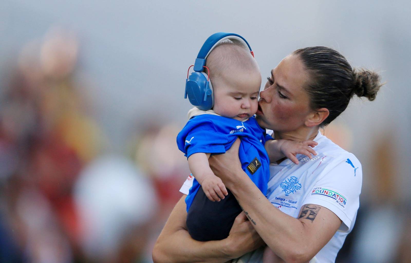 Sara Bjork Gunnarsdottir of Iceland embraces her son