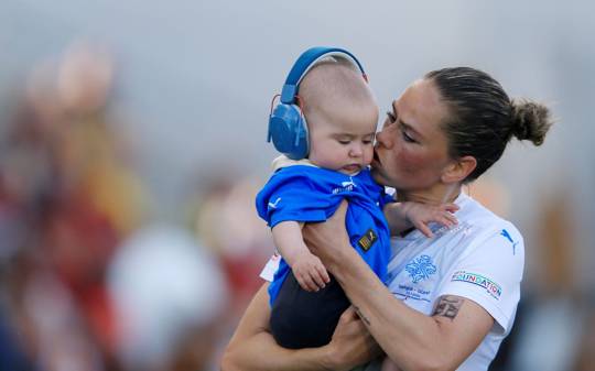 Sara Bjork Gunnarsdottir of Iceland embraces her son